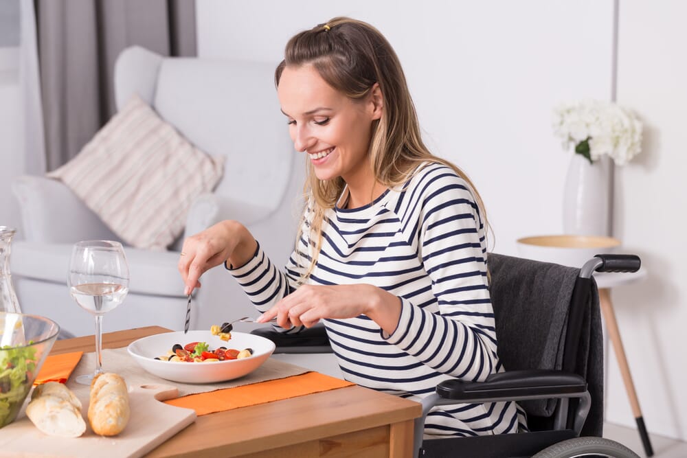 woman in wheelchair eating healthy meal