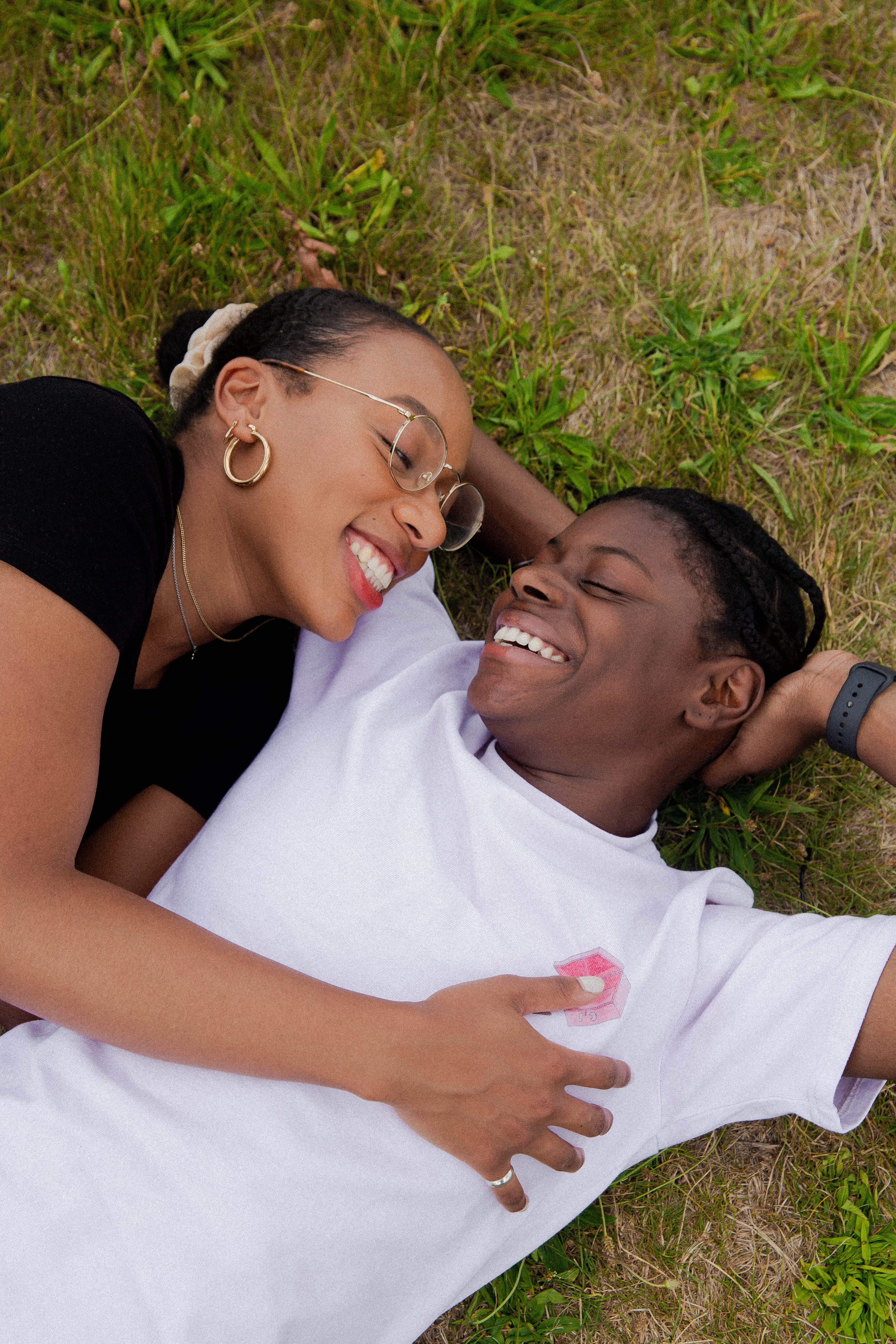 couple laughing and cuddling in the grass