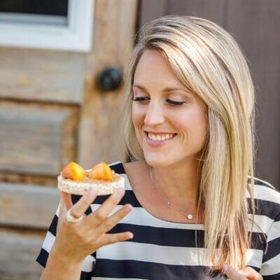 registered holistic nutritionist michelle strong eating a rice cake with fruit
