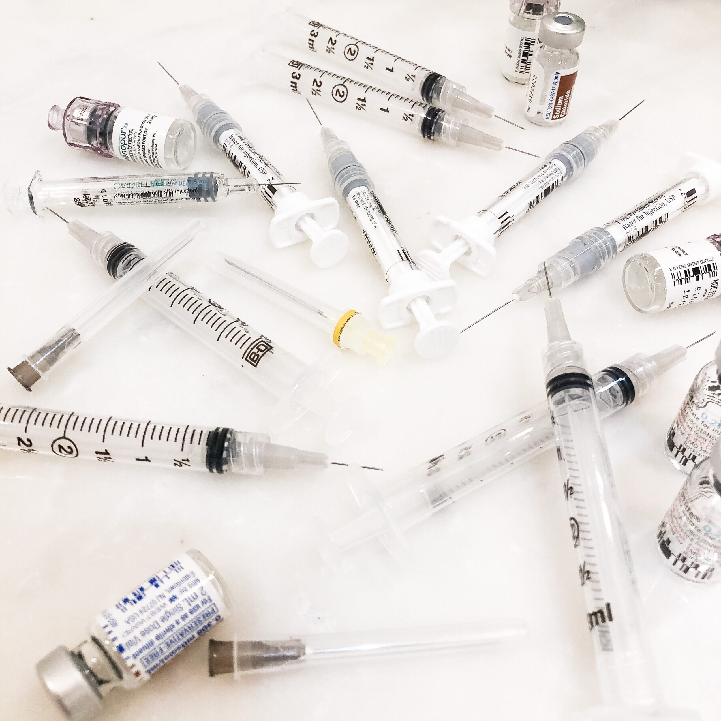 collection of ivf medicines and syringes