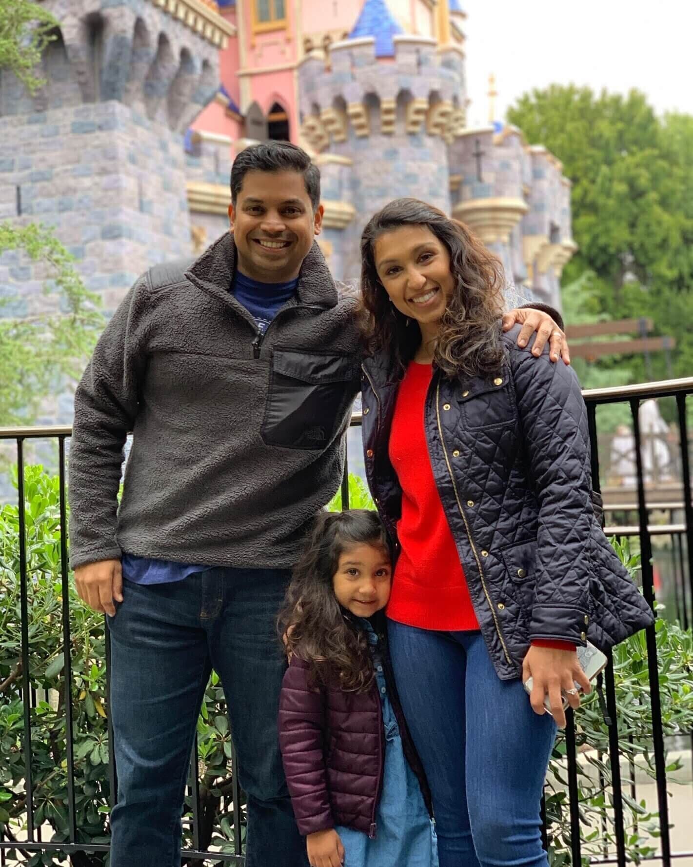 Dr. Flora Sinha with her husband and daughter at Disneyland