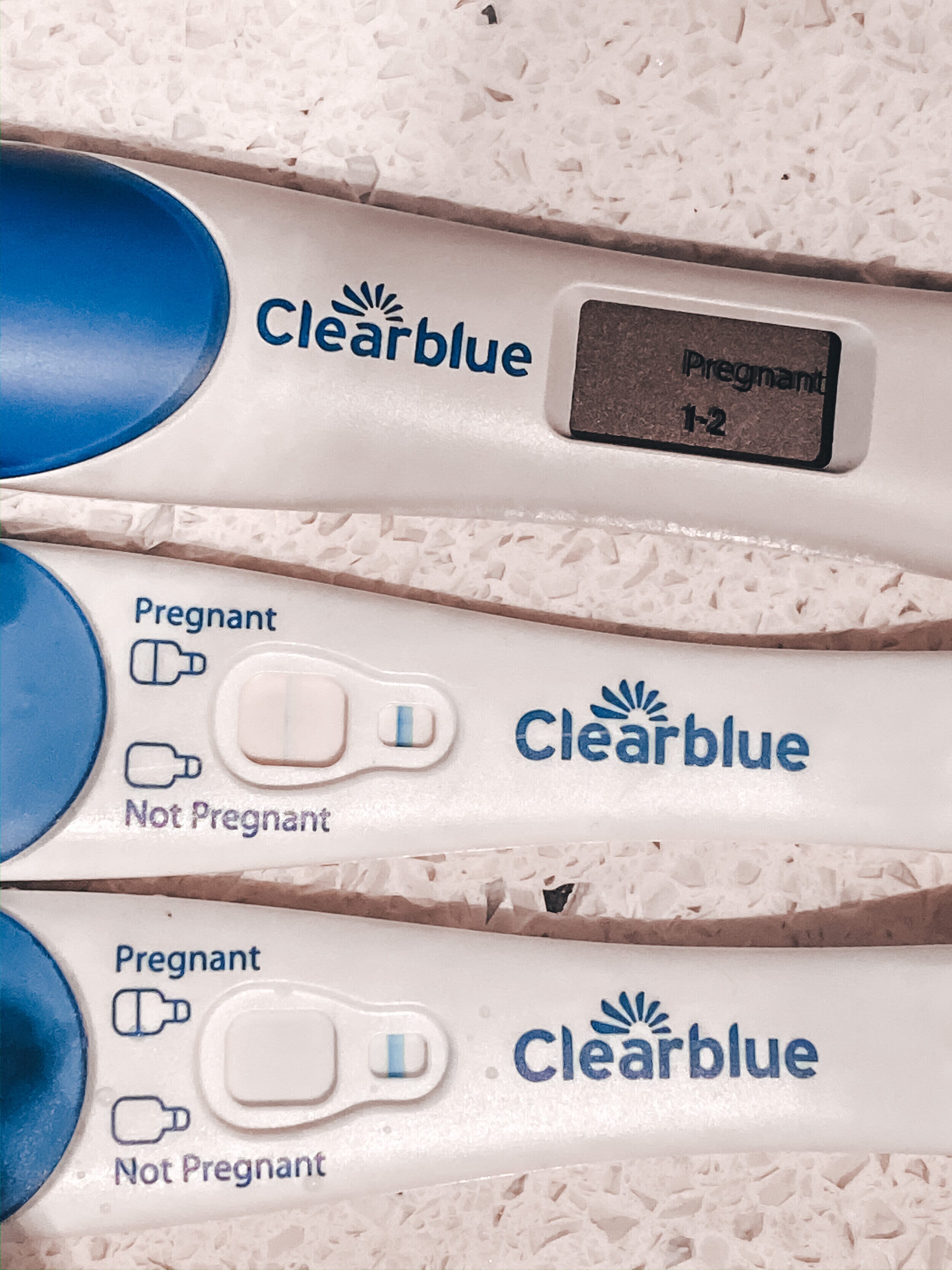 three clear blue pregnancy tests