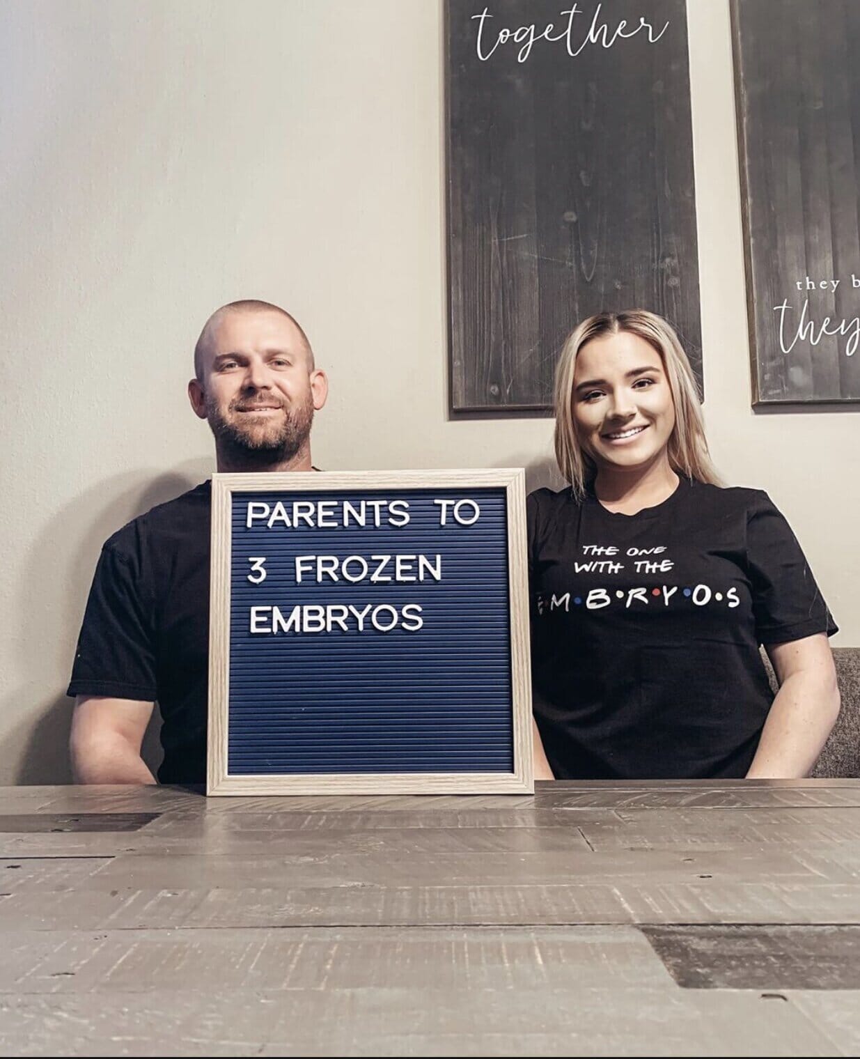infertility warrior melissa pomish with her husband and a sign that reads &quot;parents to three embryos&quot;