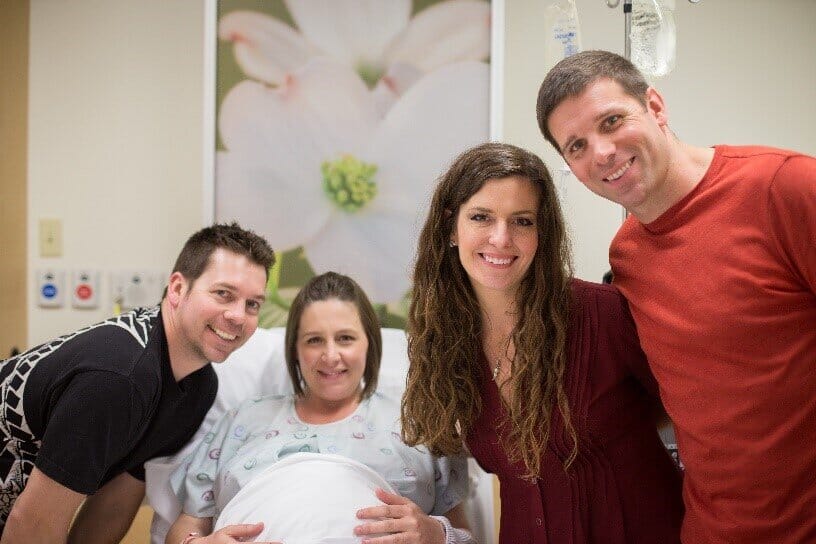 couple with their gestational surrogate