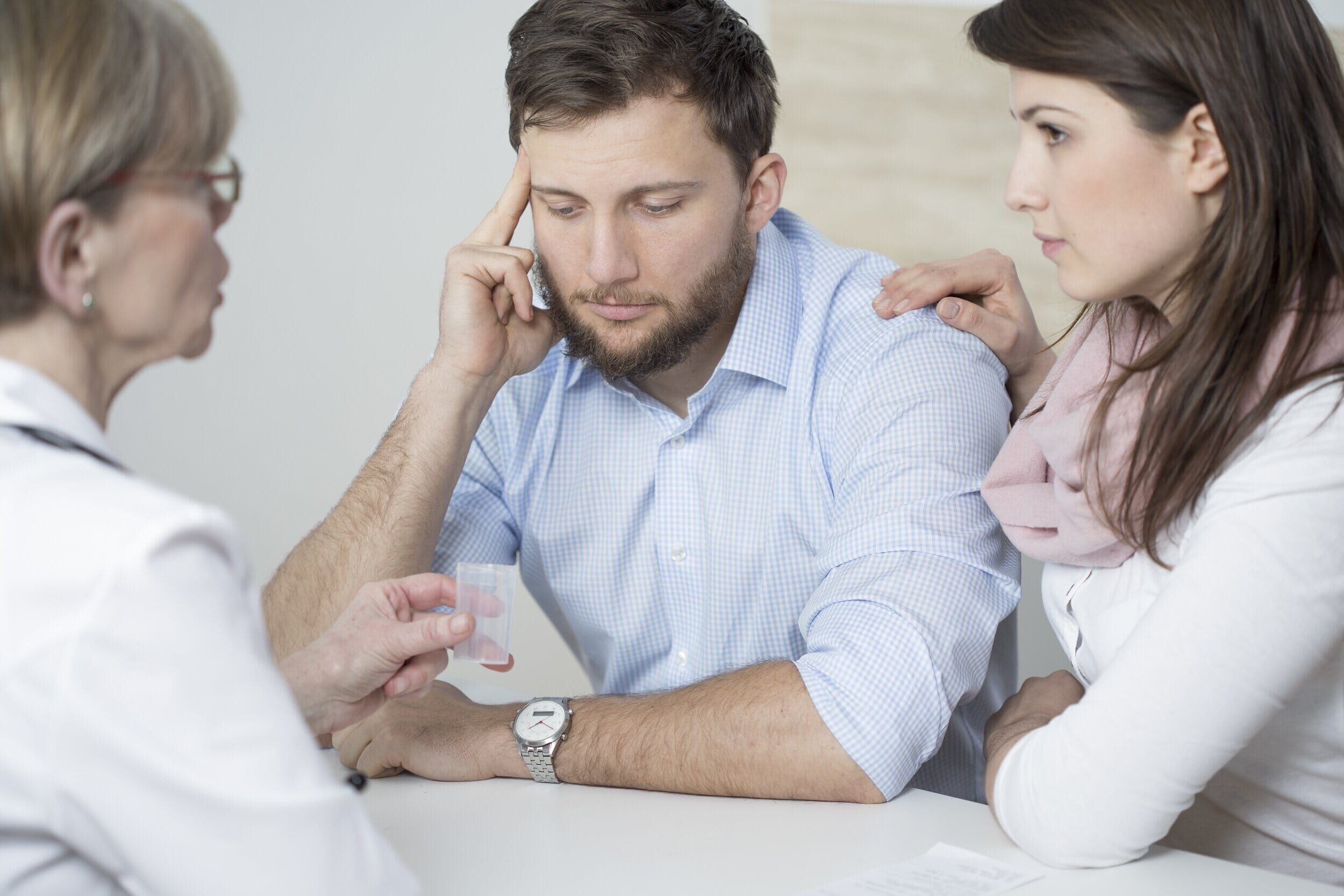 couple discussing fertility with an rei specialist at their first infertility workup