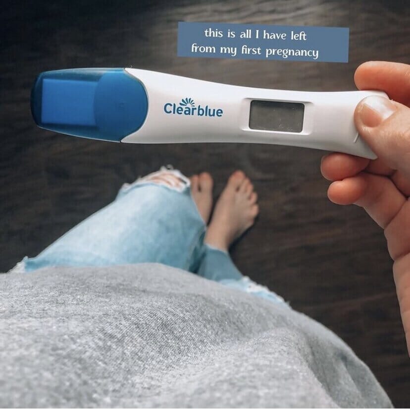 woman holding a positive pregancy test with a caption that reads &quot;this is all i have left of my first pregnancy&quot;