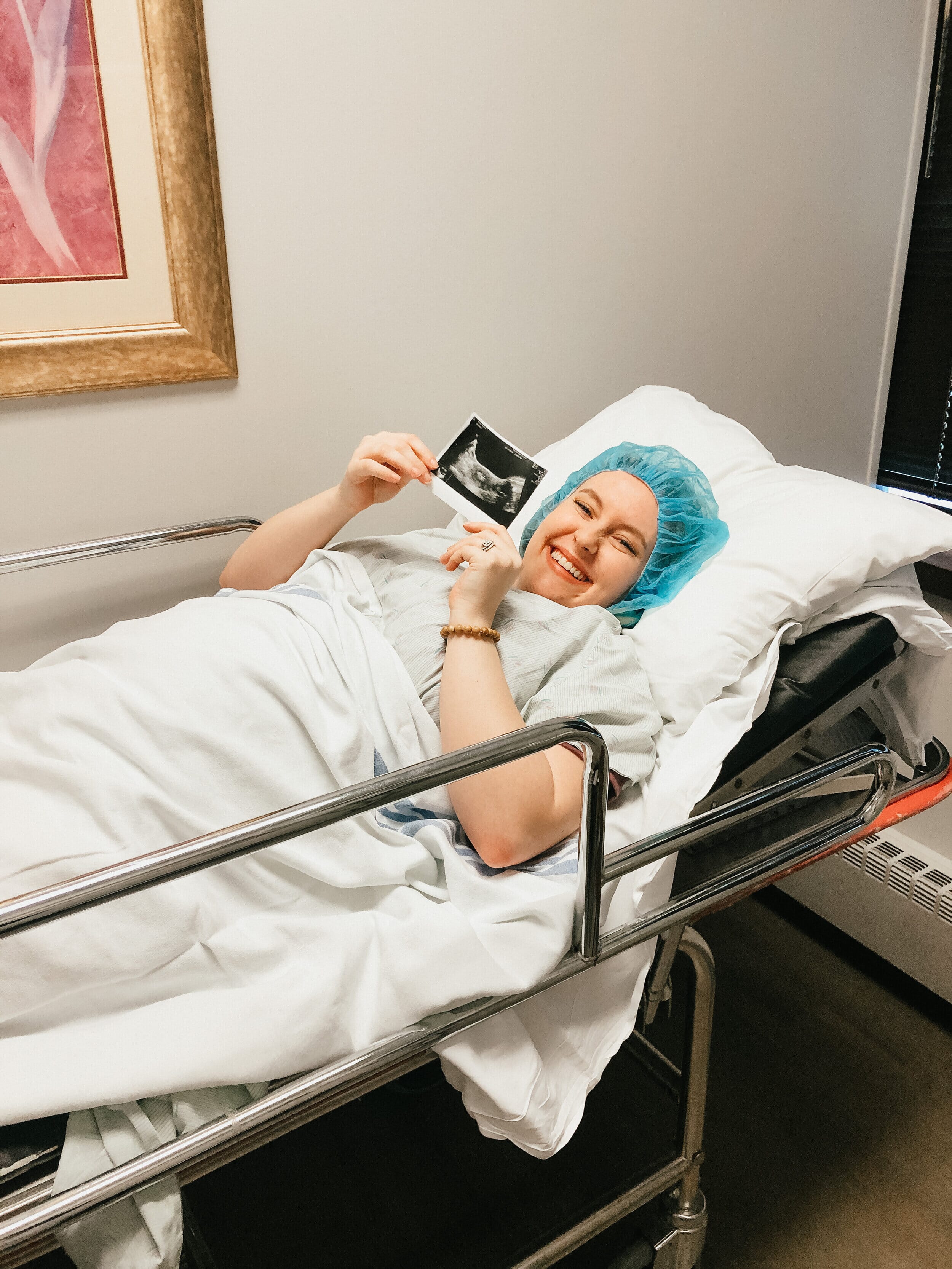 kayla kohl in the fertility clinic holding an ultrasound picture