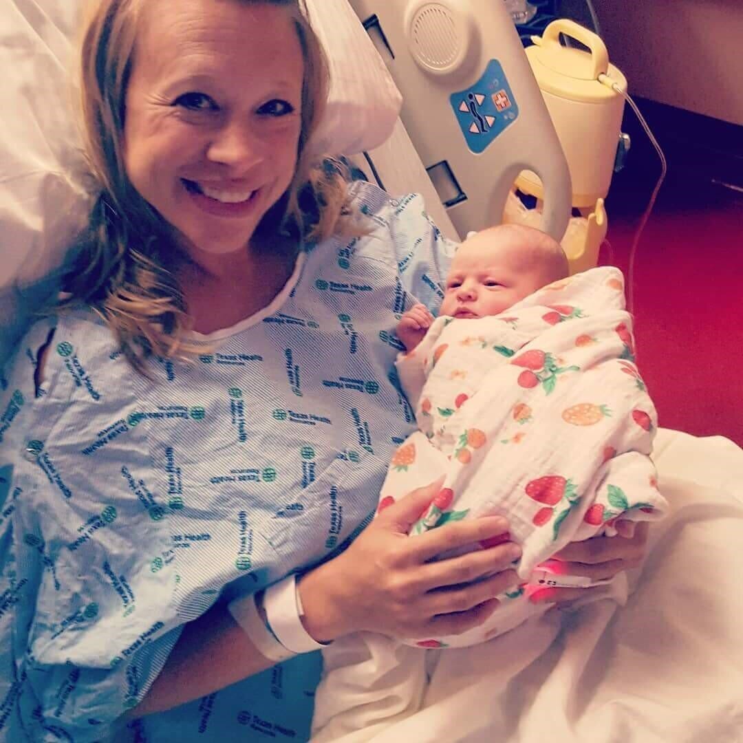 three-time surrogate tiffany jo baker holding the baby she carried