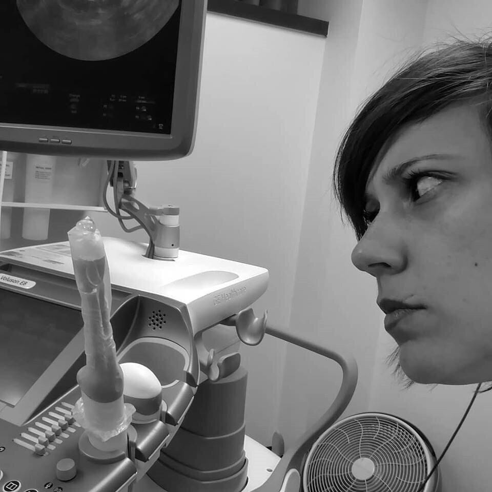 woman staring at an ultrasound wand