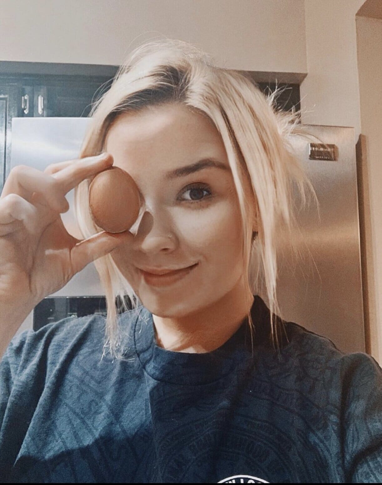 infertility warrior melissa pomish with an egg covering one eye