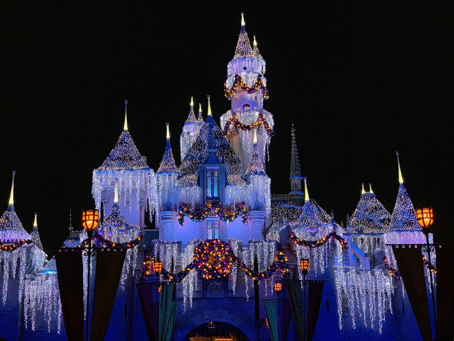 a castle decorated with holiday lights