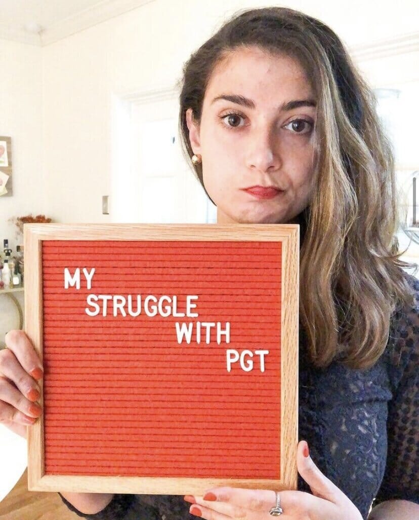 maryjane carnahan holding a sign that reads "my struggle with pgt" 
