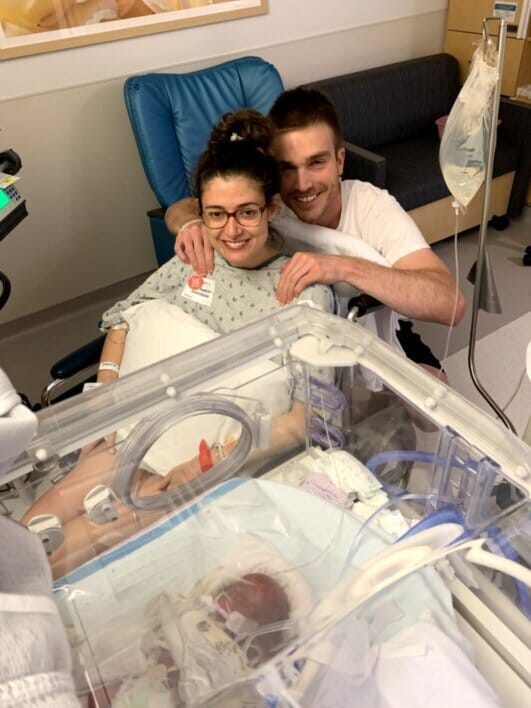 couple visiting their premature baby in the nicu